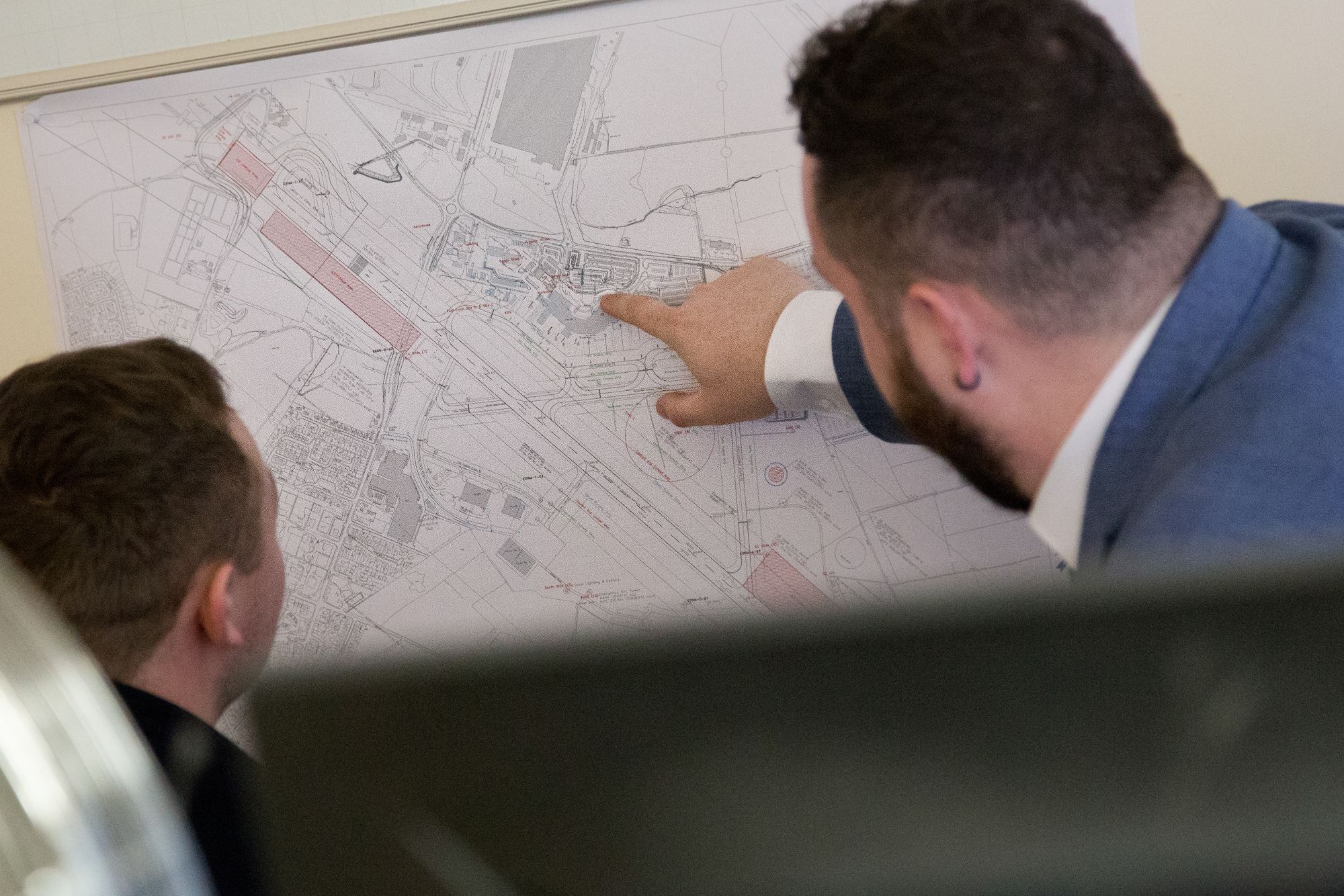 Two surveyors reviewing a site plan
